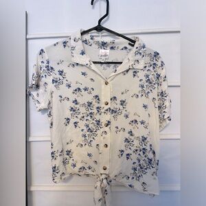 Collared floral blouse with tie in front. Belle du jour.